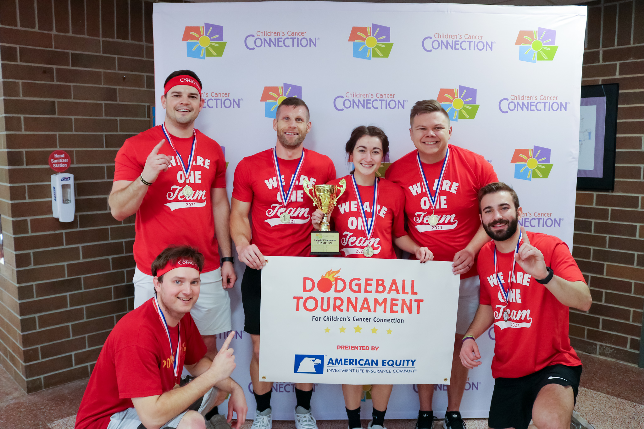 photo of winning dodgeball team posing with trophy