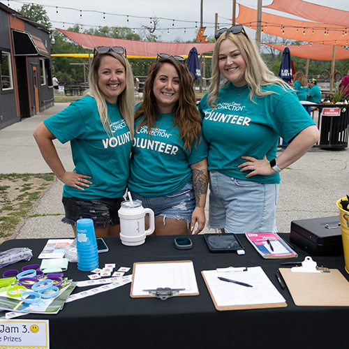 photo of three volunteers working the sign-in table at Jenna's Jam bike ride