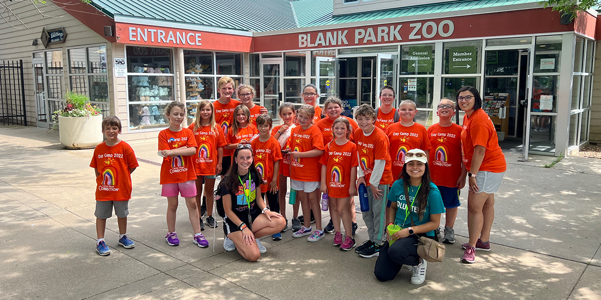 day campers in a group photo in front of the blank park zoo