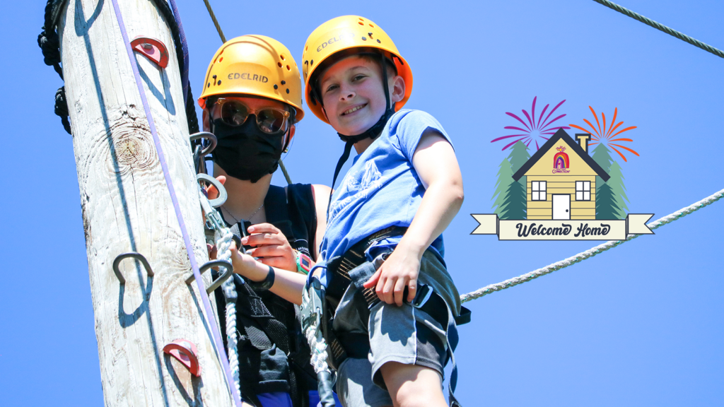 child on the climbing tower with welcome home logo