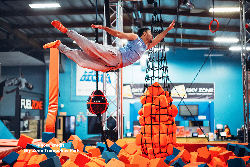 person jumping on the ninja course at sky zone