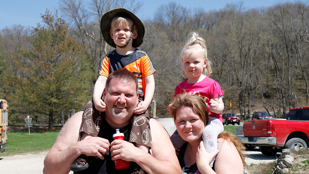 family of four smiling at spring family camp