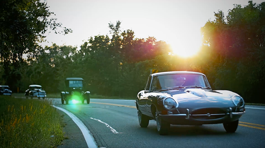 Classic cars on the road at sunset