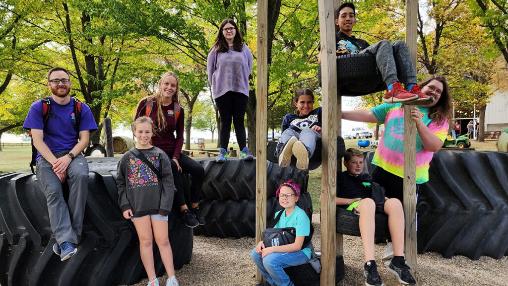 photo of teens climbing rails and tires