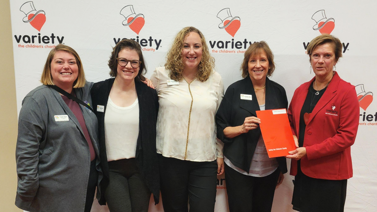 photo of CCC staff and Variety representative posing at the Variety awards breakfast