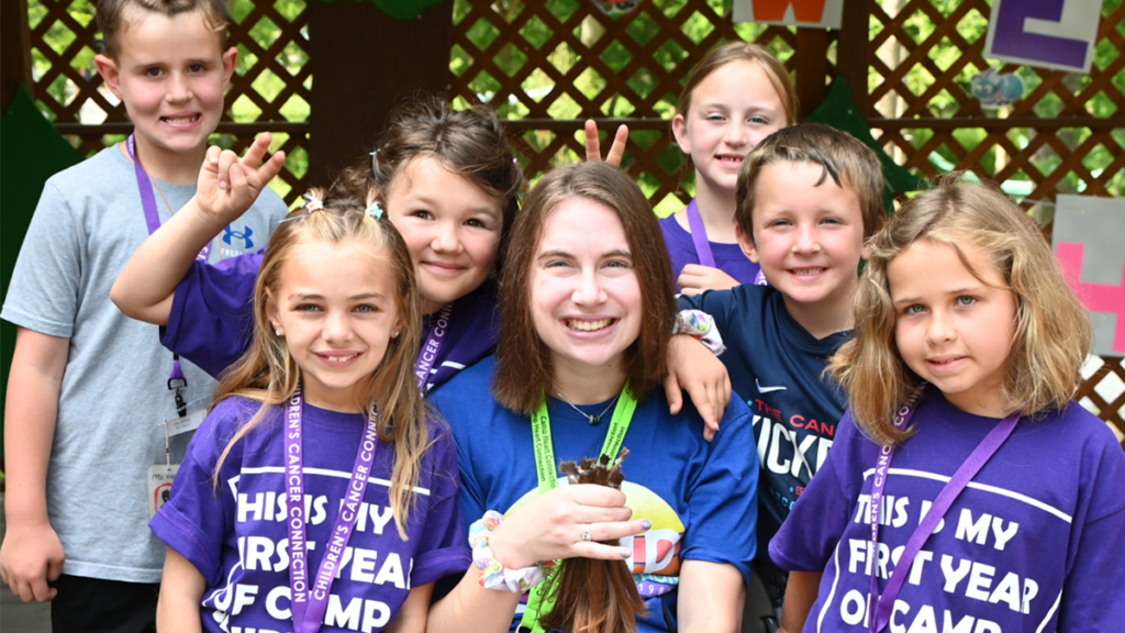 photo of first year campers smiling with counselor