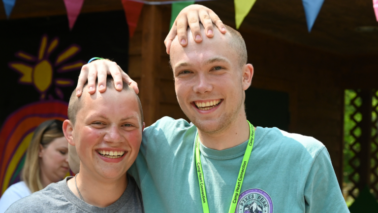 photo of volunteer and camper smiling