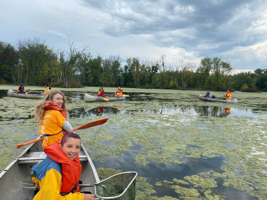 fall family campers in canoes